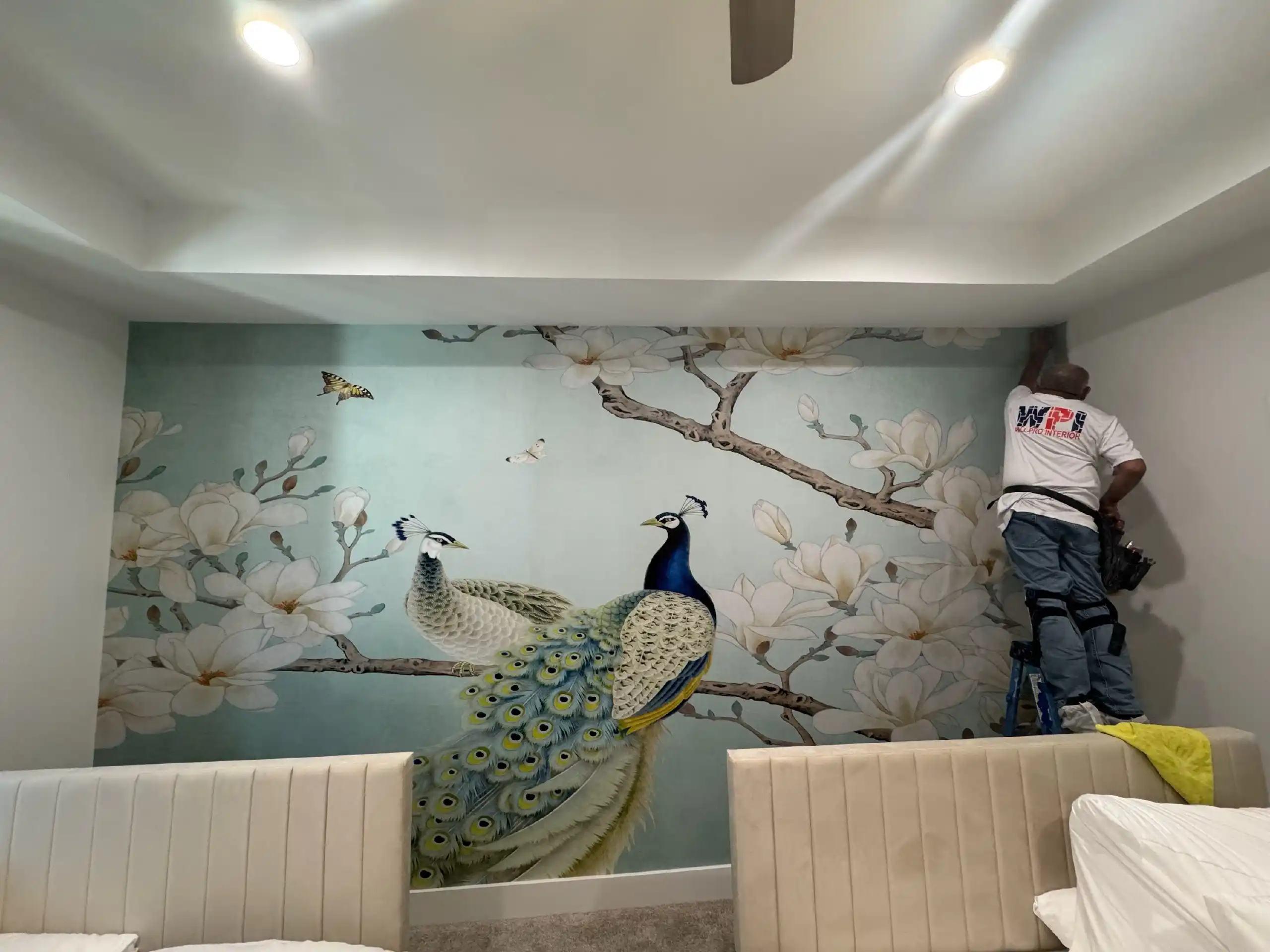 Professional wallpaper installer applying a luxury mural in a Southern California home